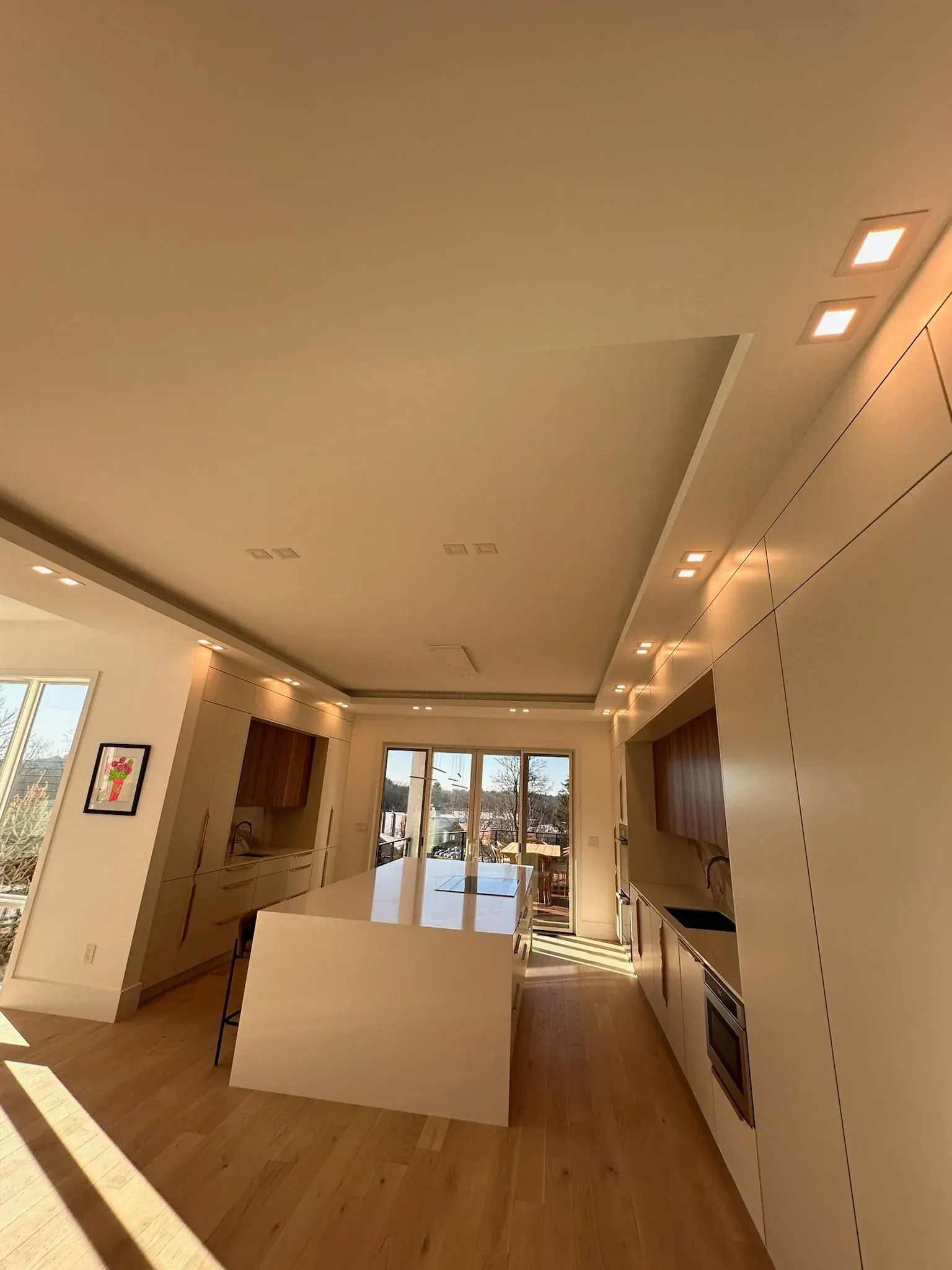 Modern kitchen with cove lighting and recessed cans